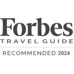 The image contains the logo of Forbes Travel Guide with its tagline "The Standard of Luxury" below it.